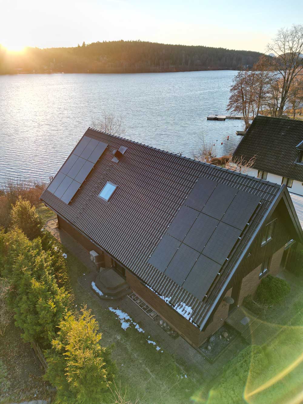 En glad byggarbetare som står på ett tak.